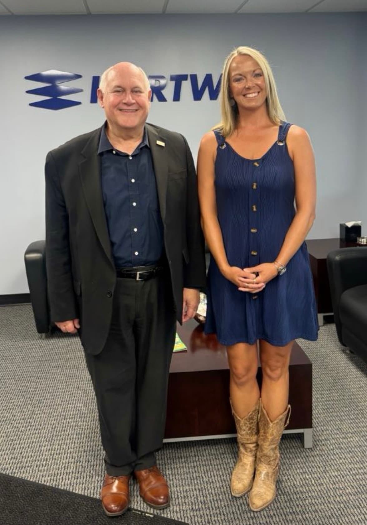 Congressman Ron Estes and Katherine O'Toole in front of the Hartwig sign