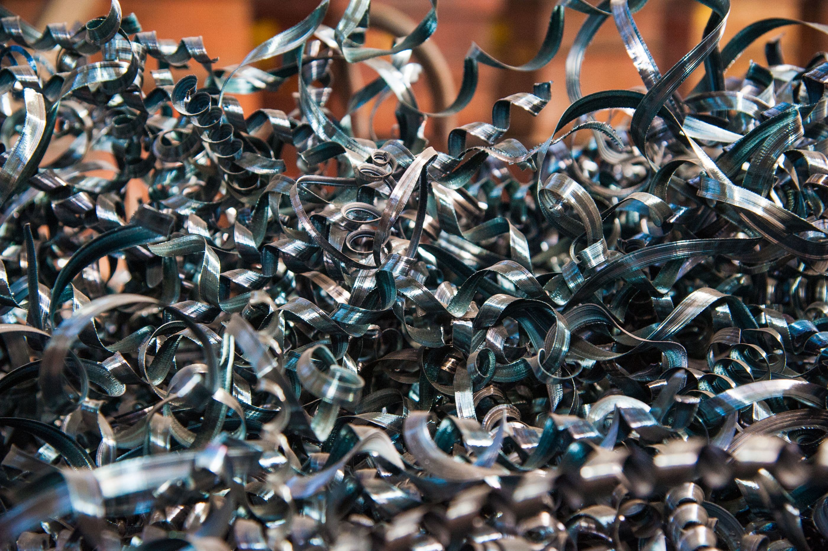 A close-up of swirling blue-tinted metal chips
