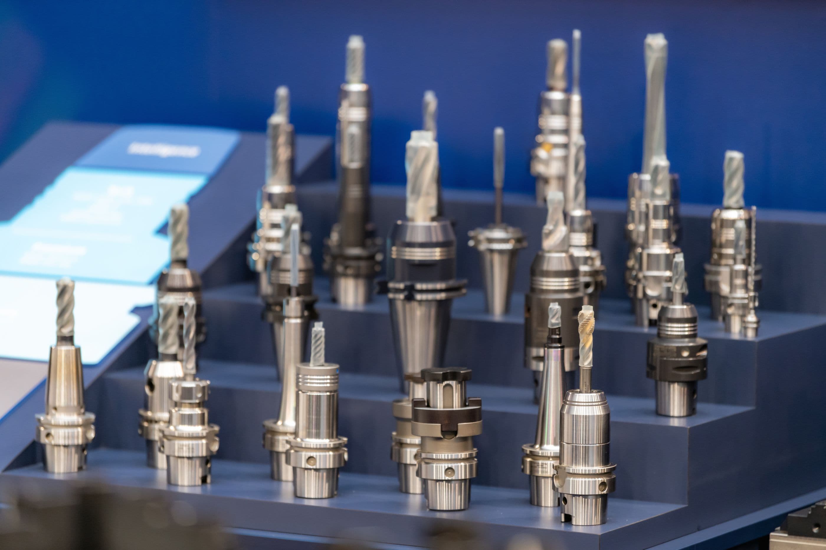 CNC tool holders with cutters lined up on a display stand