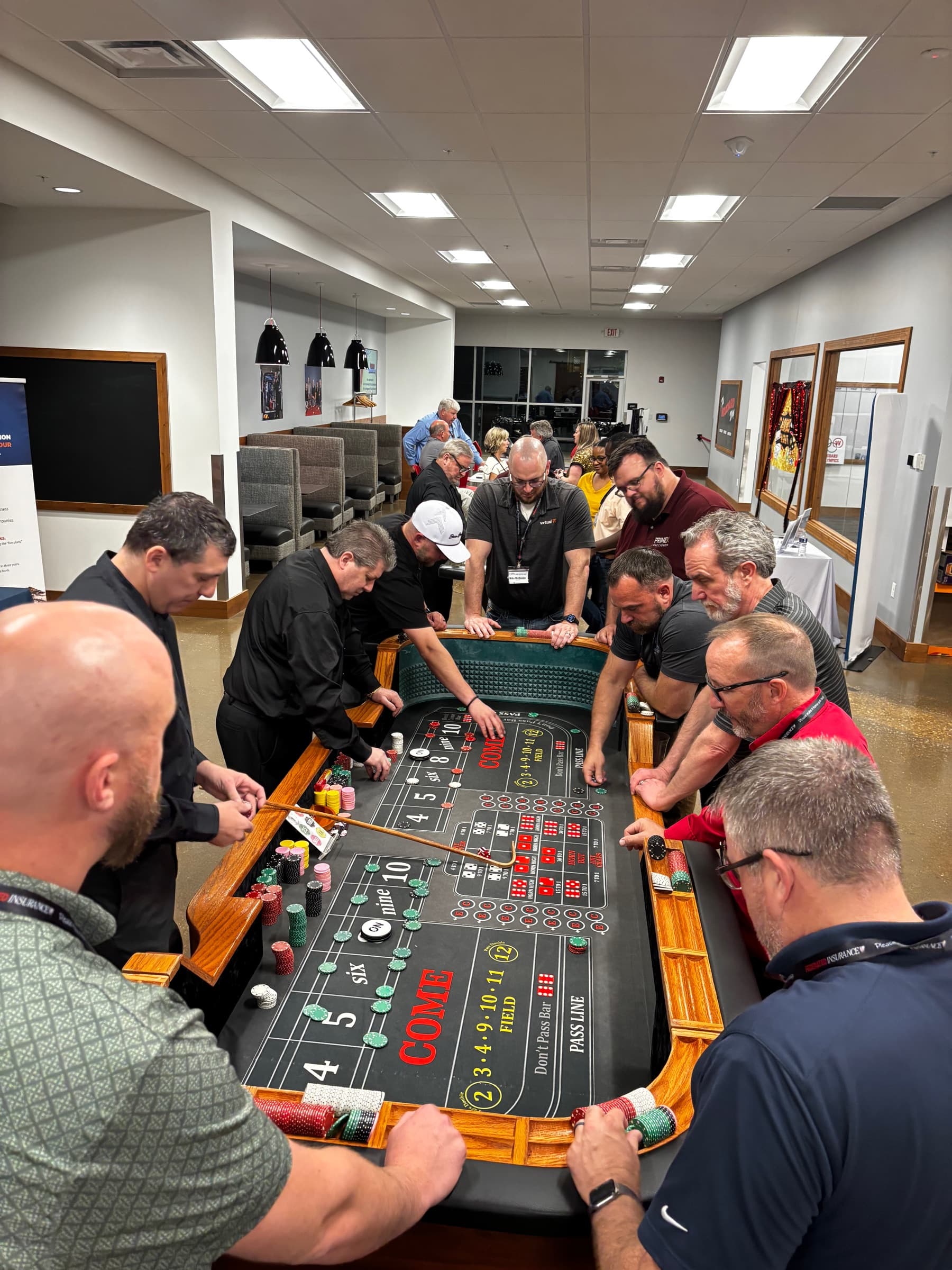 Members gathered around a craps table at a casino night