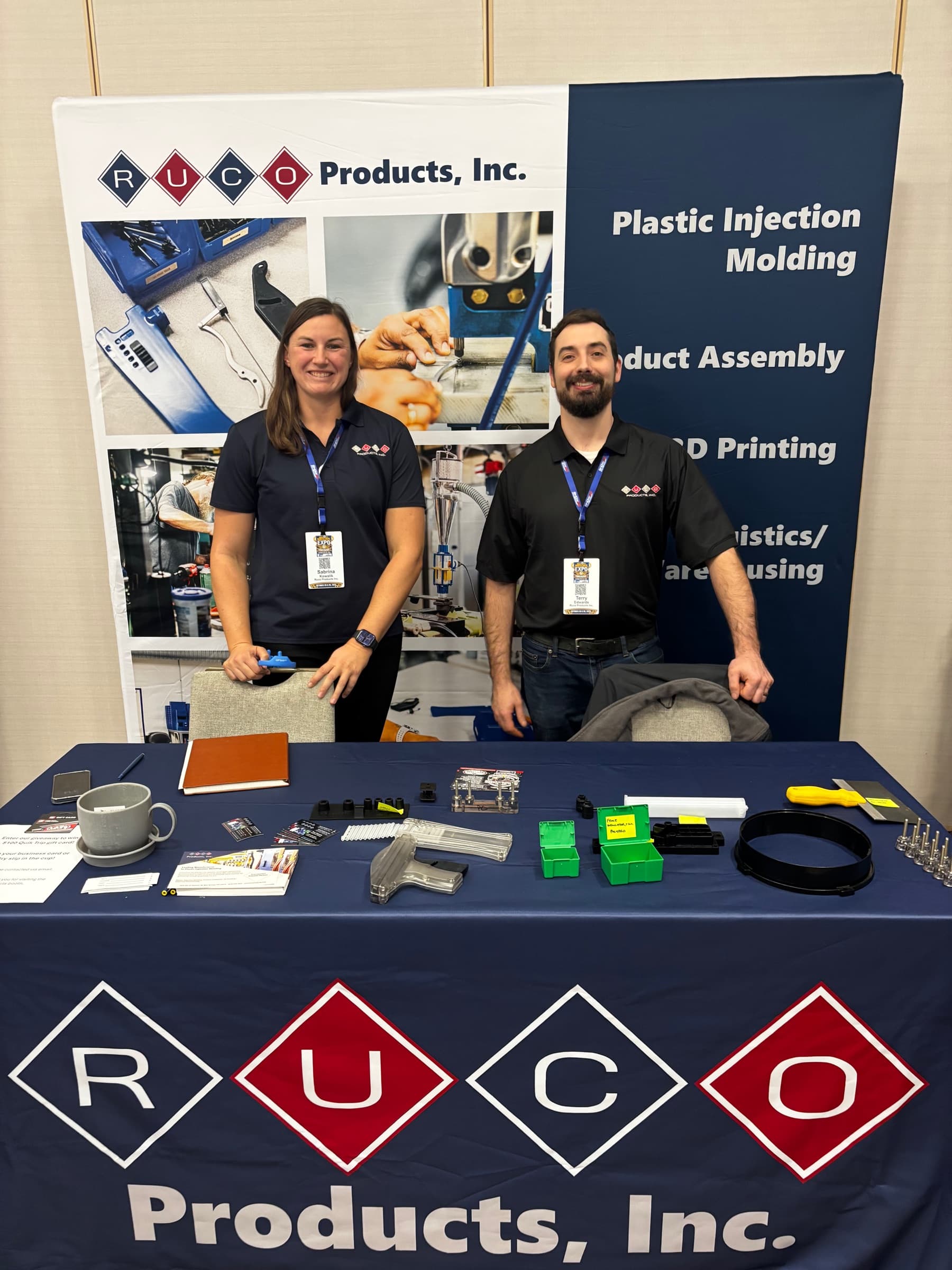 Two people from RUCO Products at their trade show booth