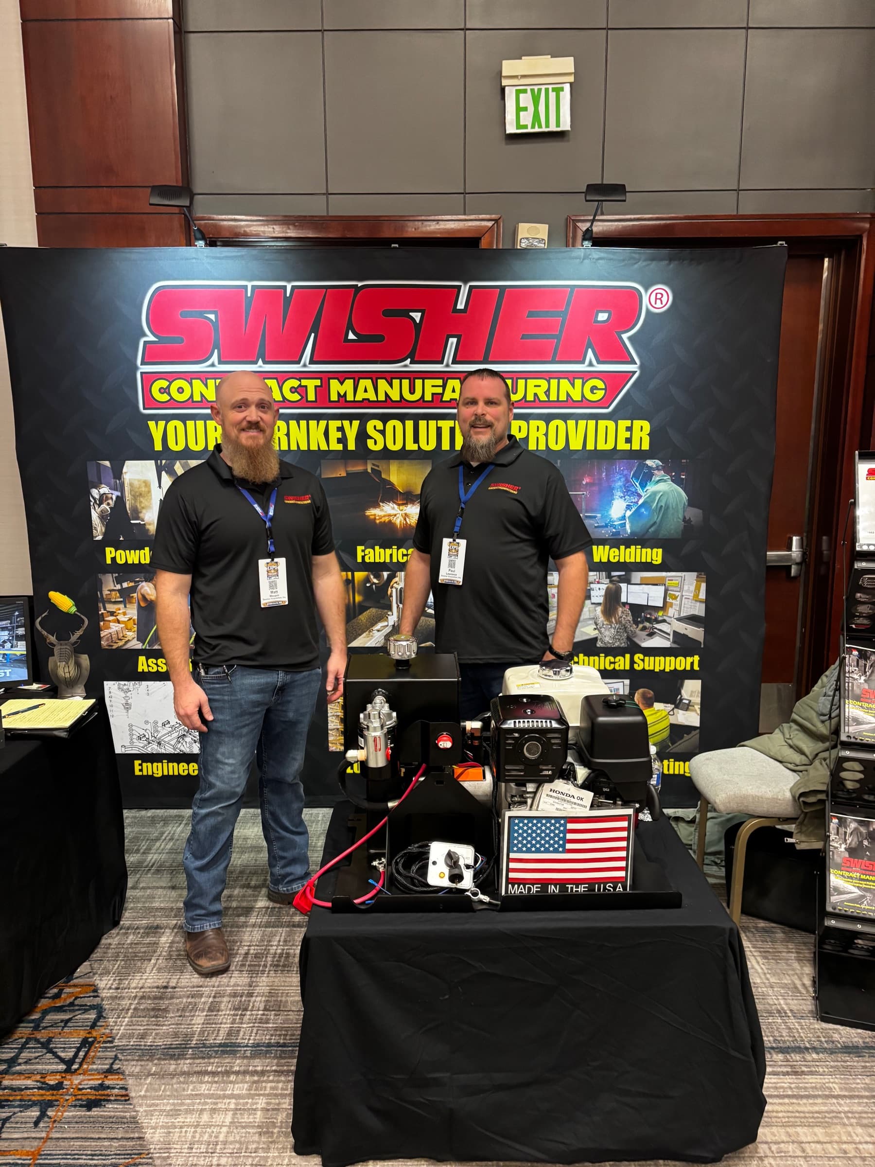 Two men from Swisher Contract Manufacturing at their trade show booth